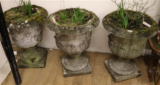 A set of 3 composition stone garden urns W.50cm